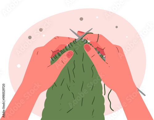 Close-up view of hands knitting a green fabric with needles, a hobby and craft activity.