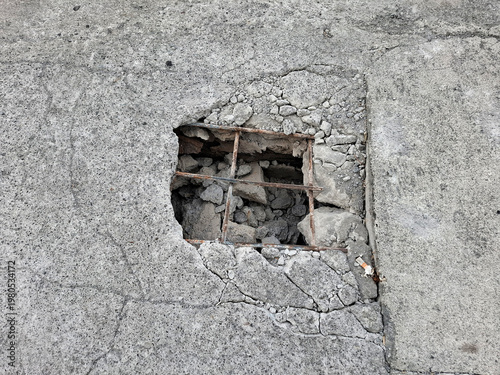 Gritty Minimalist close-up of damaged concrete with exposed rebar