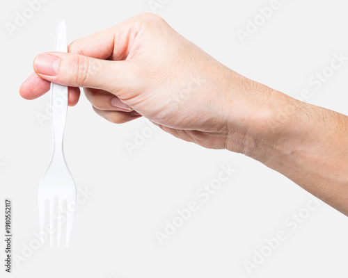 Male hand holding a white plastic fork isolated on white background with clipping path.	