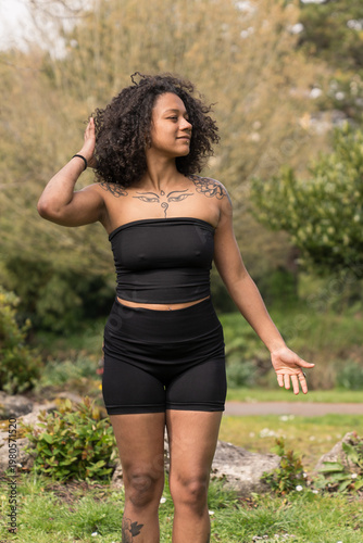 Young woman with curly hair practicing mindfulness outdoors
