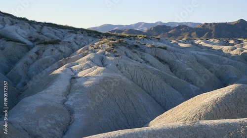 Evening in Desert – Lone Bench and Arid Terrain