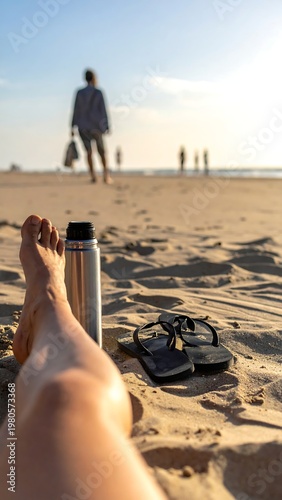 A serene beach scene with a person's legs in the foreground