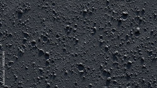 Dark, uneven surface texture exhibits numerous small craters and coarse relief under directional lighting.