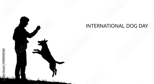 Silhouette of a person training and playing with a jumping dog for International Dog Day.