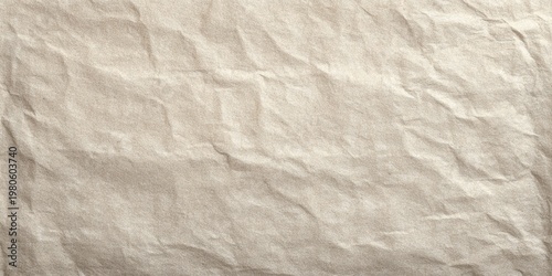 Full frame texture of aged, lightly crumpled light brown paper surface
