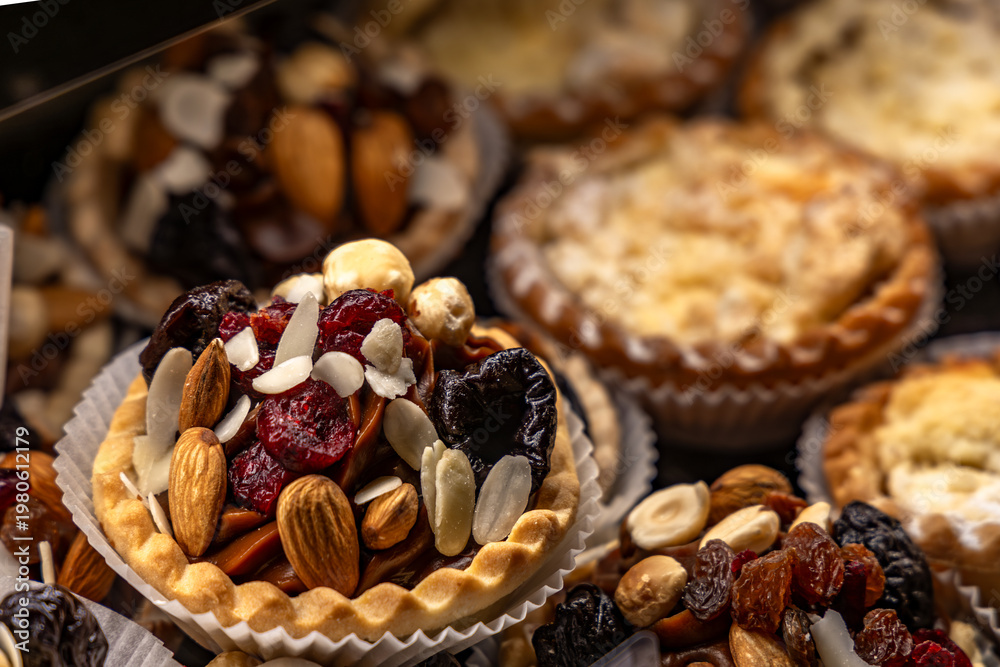Fototapeta premium Poppy seed cake with fruit arranged in the refrigerator at the pastry shop, poppy seed cake, sweet desserts baked with homemade methods, food for the holidays, light and healthy desserts made from cak