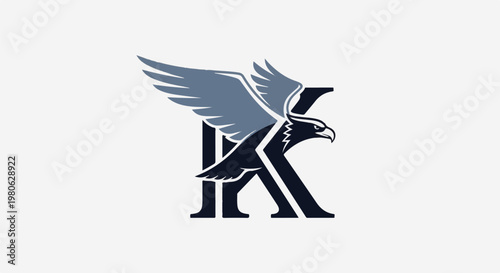 Dark eagle with grey wings perched on a dark capital letter K