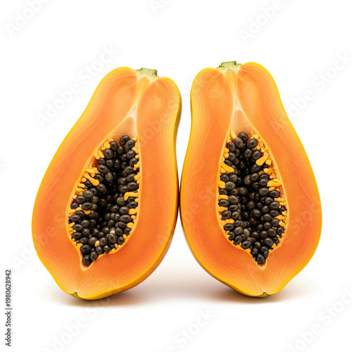 A halved papaya with black seeds on a white background