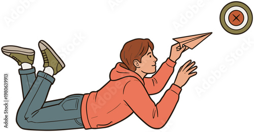 Man lying on stomach throws paper airplane at bullseye target