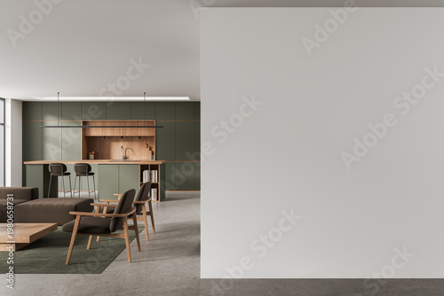 Modern minimalist interior featuring open kitchen with wooden accents, olive cabinetry, contemporary furniture and large blank wall mockup for design presentations. 3D Rendering