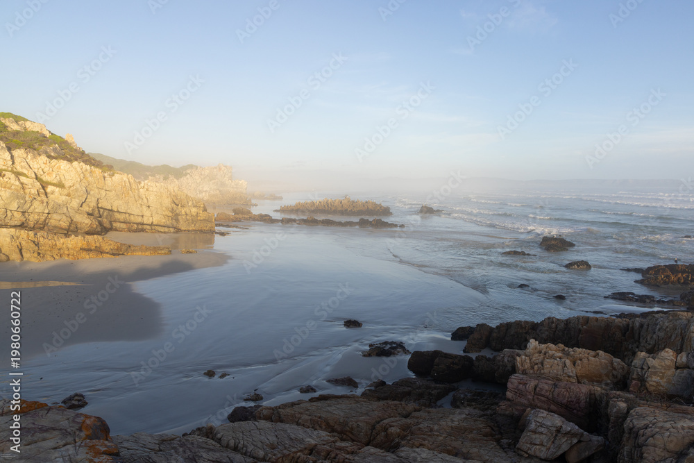Fototapeta premium rocky coastline at sunset Kammabaai Beach, Hermanus, South Africa