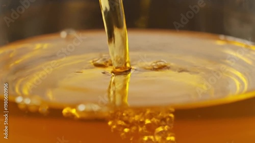 Wallpaper Mural Macro Shot of Golden Liquid Pouring into a Glass Creating Ripples and Bubbles for Food and Beverage Concepts Torontodigital.ca
