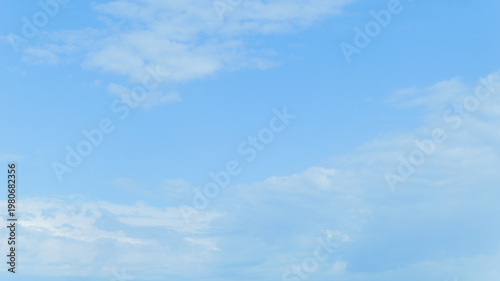 Obraz na płótnie Vast expanse of clear blue sky with scattered white clouds on a bright day