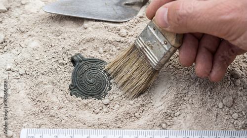 Ancient artifact discovery during archaeological excavation in dirt