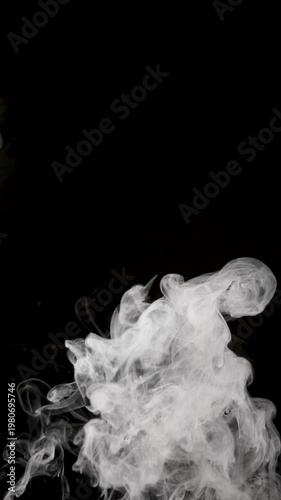Soft white smoke forms intricate swirling patterns against a deep black background, creating an abstract, fluid composition with strong contrast and elegant motion. Copy space