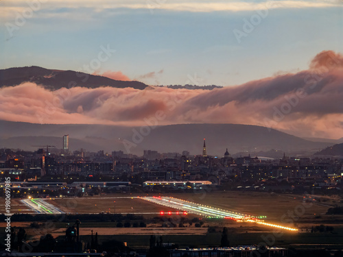 Cluj airport runway with landing lights and dramatic clouds sunset