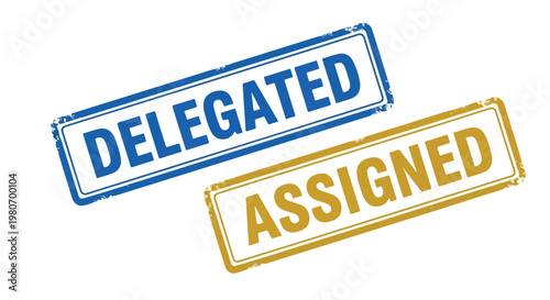 Close-up of two rubber stamps with the words delegated and assigned in blue and gold ink on white background