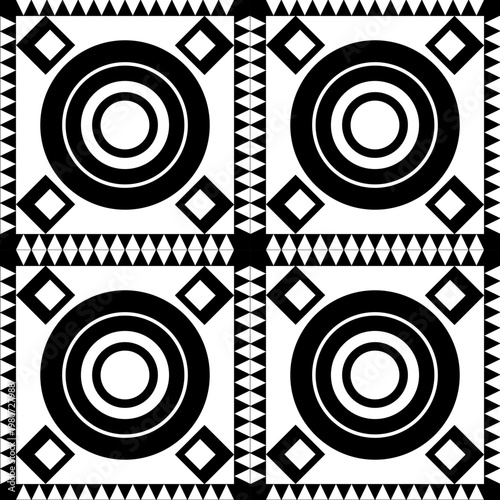 A detailed, repeating geometric motif with concentric circles, diamond squares, and a saw-tooth border