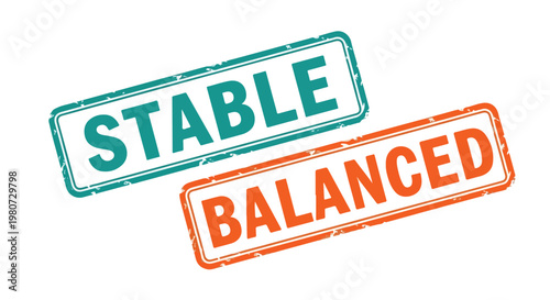 Close-up of two rubber stamps with the words stable and balanced in vibrant colors on white background