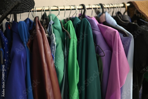 Rack with different stylish women`s clothes 