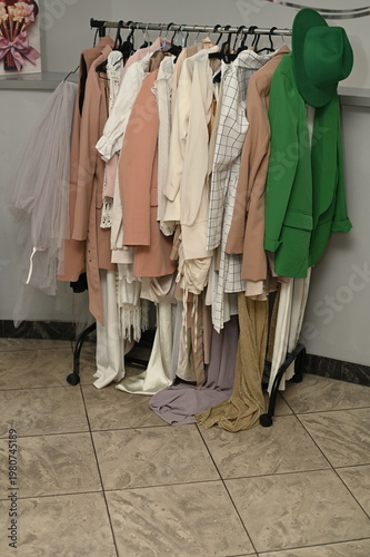 Rack with different stylish women`s clothes 