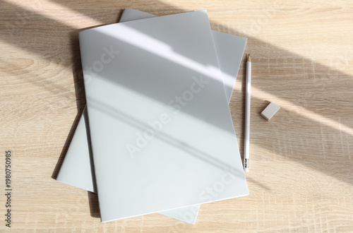 Corporate business books or notebooks with pencil on table with shadow. Mockup for design