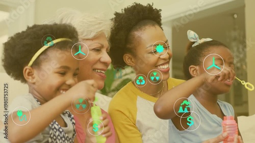 Family playing bubbles on sofa, blowing bubble wands, green energy icons covering lower frame