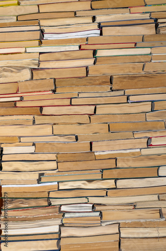 Books stacked on top of each other in a library or warehouse, beautiful book background