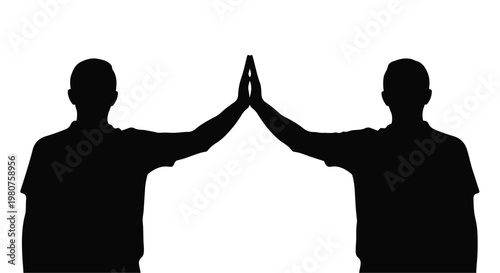 Silhouette of two people giving a high five representing success and teamwork.