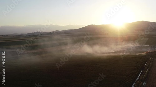 Aerial Drone View of Dense Smoke from Stubble Burning Covering Agricultural Fields at Sunset