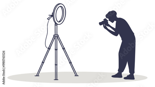 Silhouette of a person taking a photo in front of a camera with a ring light on a tripod stand