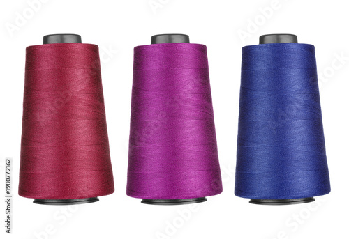 Three vibrant spools of glittery sewing thread in different colors displayed together isolated on transparent background