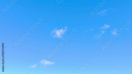 Little clouds are moving in the sky at noon