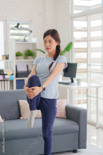 Free Download Asian adult woman stretch leg at home living room fitness workout daily exercise routine maintain body health indoors physical activity wellness training yoga - GFXLoad