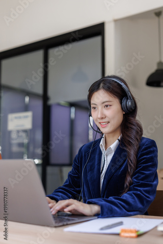 Young asian woman providing online customer service with laptop