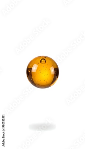 Single glossy honey candy droplet suspended in air with dark specks