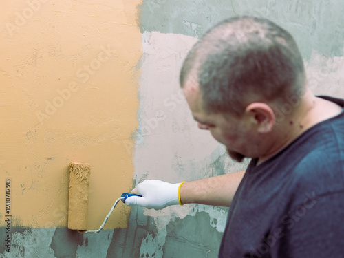 Wallpaper Mural Man paints wall with a roller Torontodigital.ca