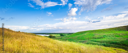 Wallpaper Mural Golden grass sways gently beside emerald hills Torontodigital.ca