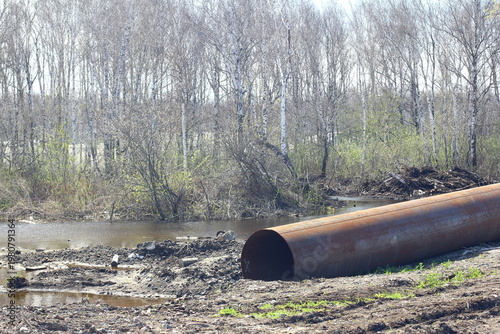 Careless attitude towards nature. Uprooted trees, flooded forests, pollution and industrial waste products of oil refining. Extraction of minerals by open method.