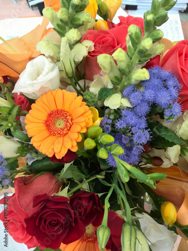 Beautiful mixed flower arrangement featuring gerbera daisies, roses, and statice