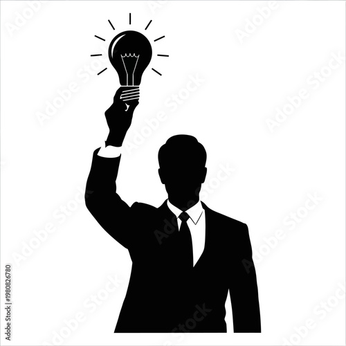 Silhouette of a Businessman Holding a Glowing Light Bulb Upward.
