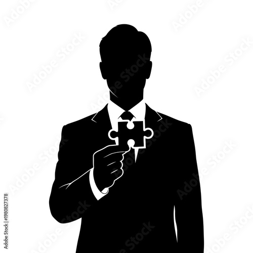 Silhouette of a Businessman Holding a Puzzle Piece.