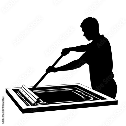 Man applies ink with roller to screen