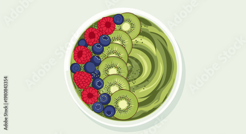 A vibrant green smoothie bowl topped with kiwi slices, blueberries, and raspberries
