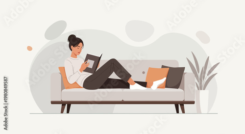 Woman relaxing on sofa reading a book 1.