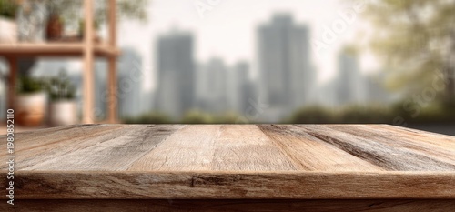 Empty wooden table in foreground, blurry city skyline and potted plants in background