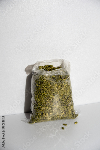 peeled pumpkin seeds in a bag, with shadow