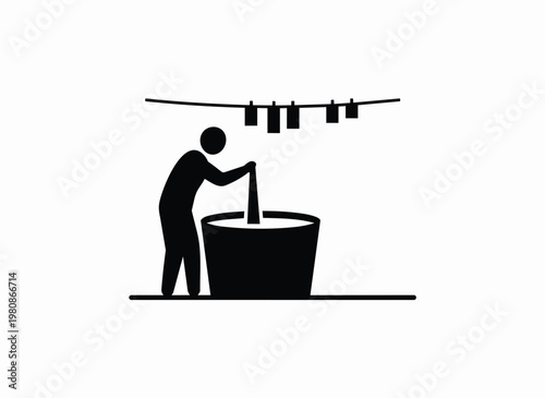 Person stirring in large tub with clothes hanging on line above, silhouette icon.