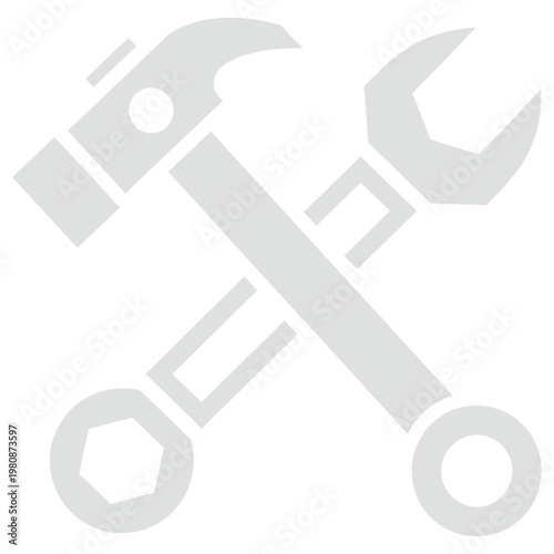 A hammer and wrench crossed over each other on a workbench indoors.