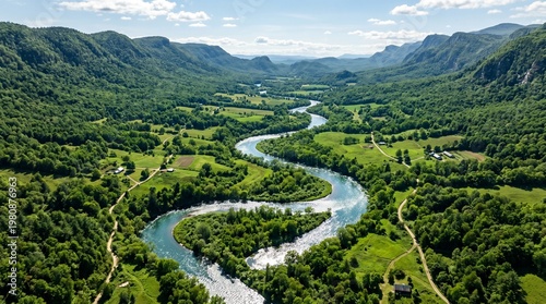 Foto Aerial view of a serene river winding through a lush green valley surrounded by